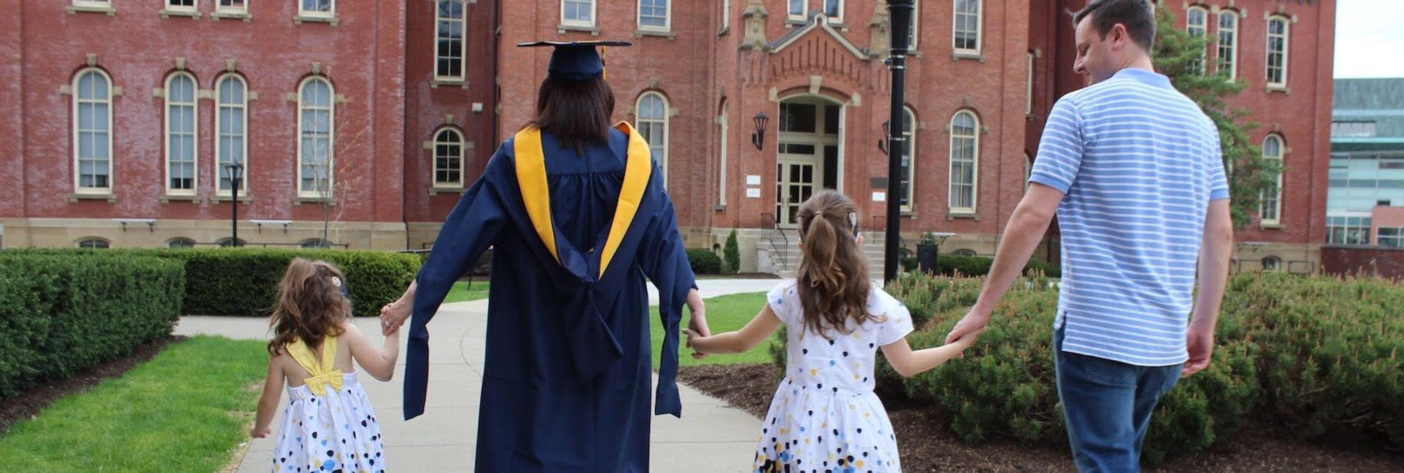 WVU family walking holding hands